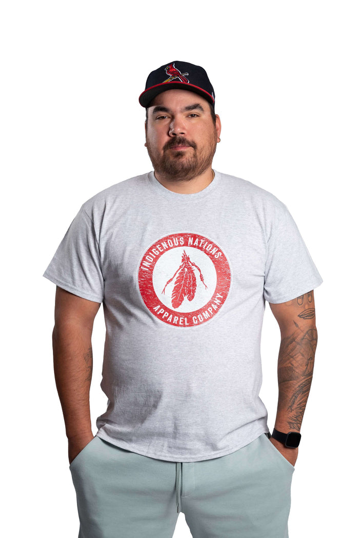 Man wearing a white INAC Distressed Feather tee front view