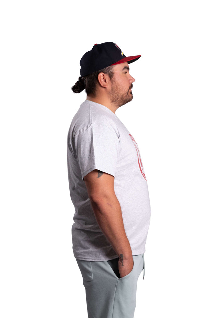Man wearing a white INAC Distressed Feather tee side view