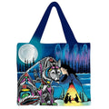 Tote bag with a colorful design of a wolf and person by a campfire under a moonlit sky.