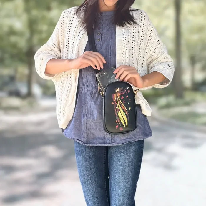 Woman wearing a Leaf Dancer Phone Bag, showcasing its design and features in a natural outdoor setting.
