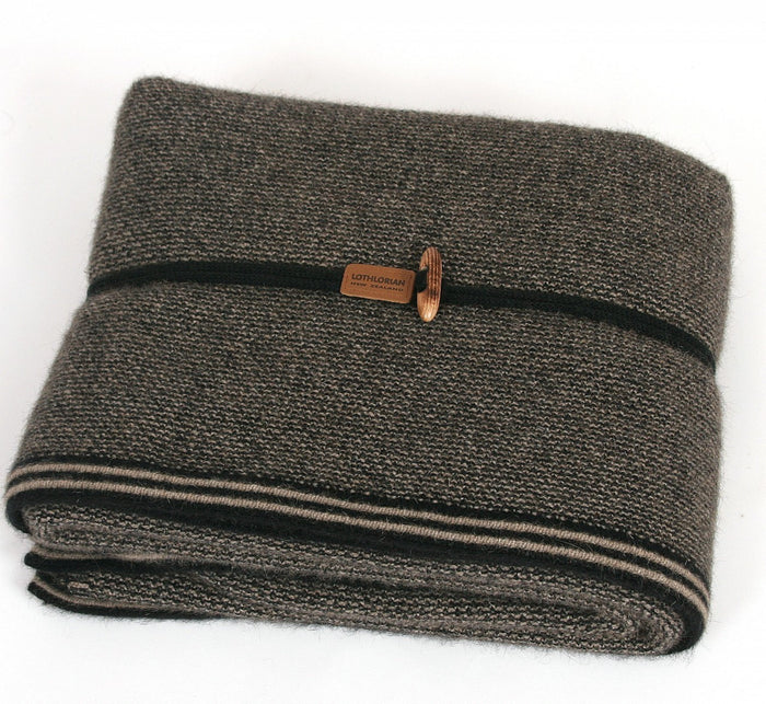 Lightweight blanket folded up. Colour Black/Natural