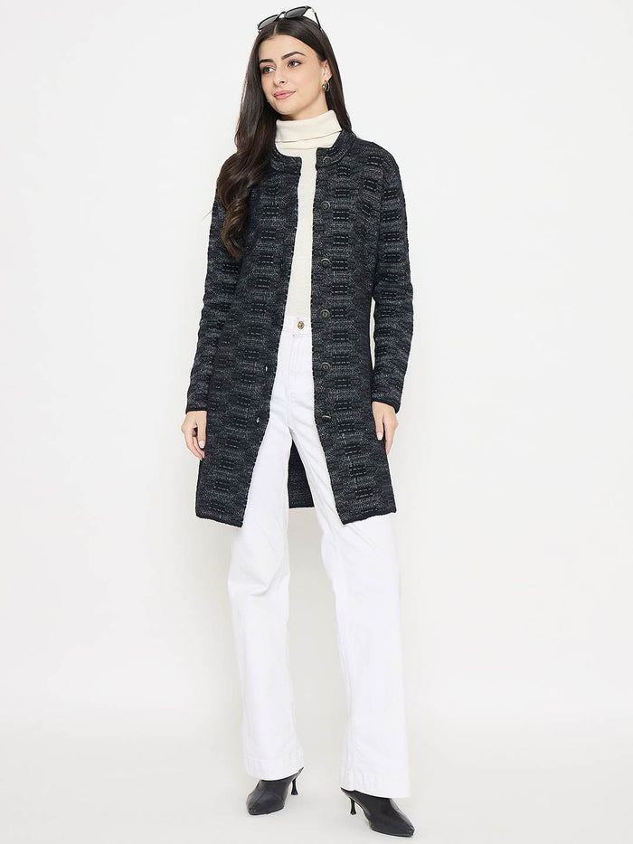 Madame Self Design Black Cardigan worn over a white turtleneck and paired with white pants, showcasing its elegant texture.
