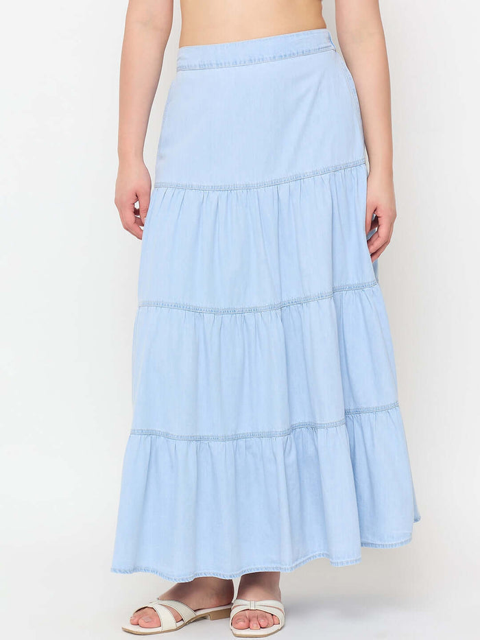Light blue tiered skirt worn by a person on a white background