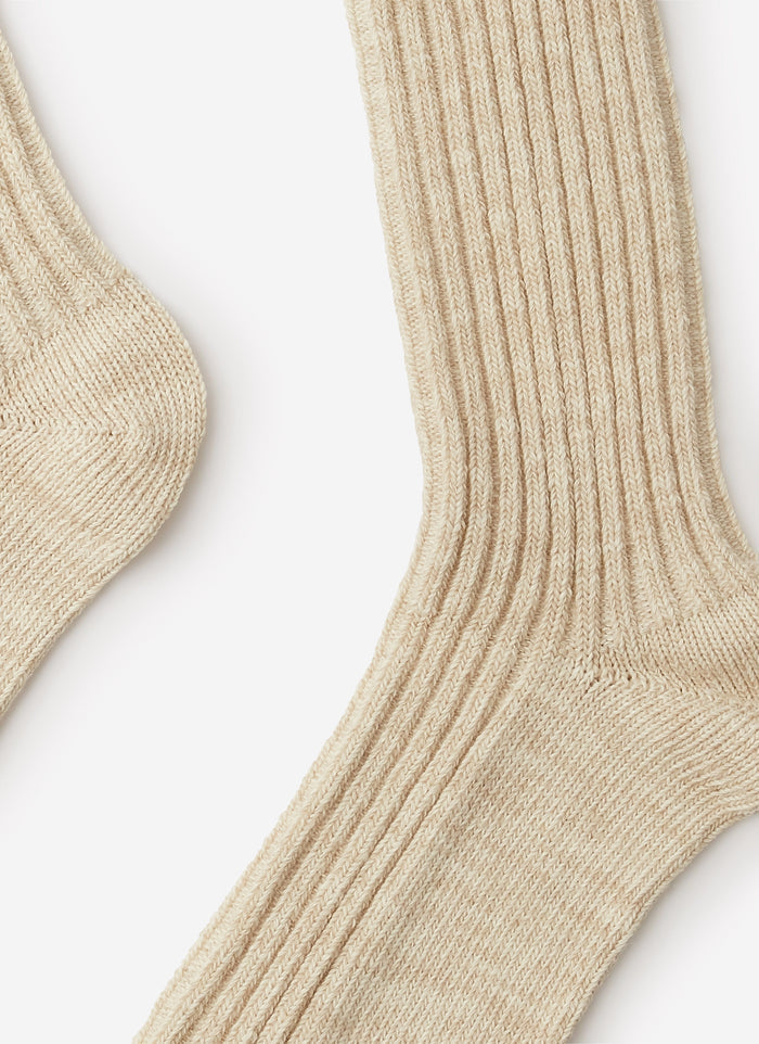 A detailed close-up of the ribbed cotton-blend texture on the Percival Marl Socks in an oat colour.