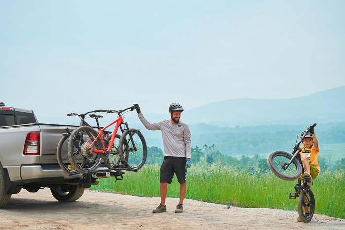 Rider loading a bike onto the Saris MHS UNO 1-Bike Modular Hitch Rack