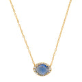 Gold oval gemstone pendant necklace with blue center stone and halo of clear crystals