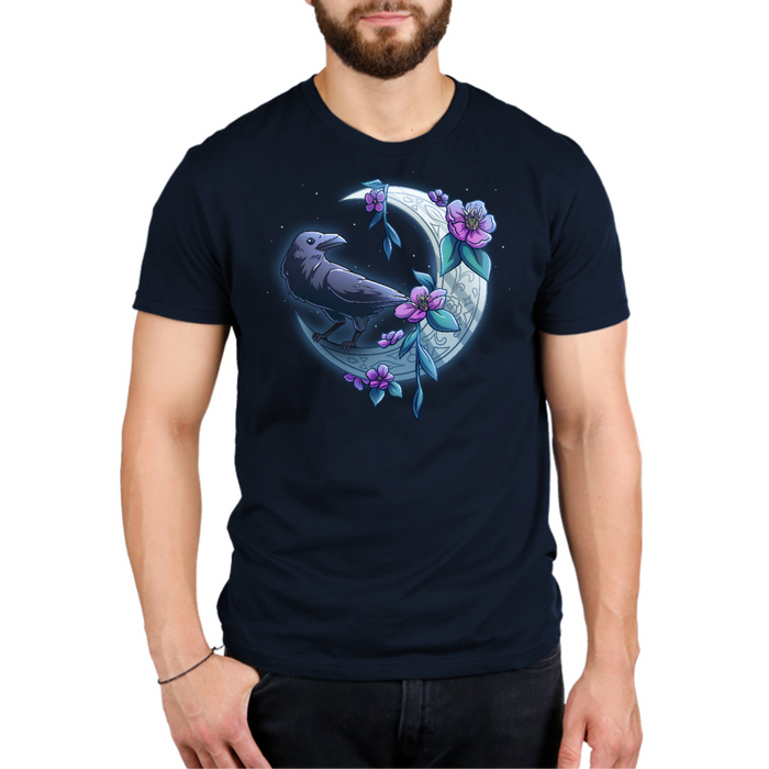 Premium Cotton T-shirt_TeeTurtle navy blue Midnight Perch Premium Cotton T-shirt featuring a raven perched and glowing atop a fancy crescent moon with pink flowers and stars in the background