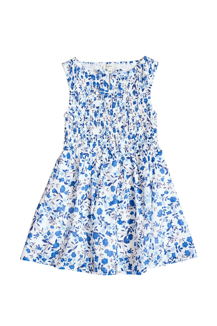The Mini Ana Dress in Ditsy Cobalt Floral by Ivy City Co is a sleeveless white girls' midi dress with blue floral print, smocked bodice, and flared skirt—ideal for matching family dresses or cute mom and me outfits.