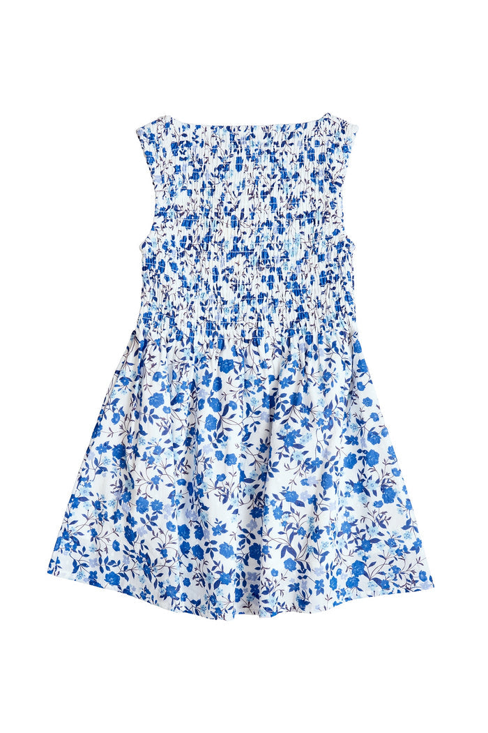 The Mini Ana Dress in Ditsy Cobalt Floral by Ivy City Co is a sleeveless girls' midi dress with a smocked bodice and flared skirt, featuring a white base with blue florals—ideal for matching family looks or mom and me outfits.