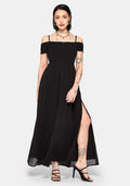 Woman wearing a black off-shoulder maxi dress with a thigh slit on a white background