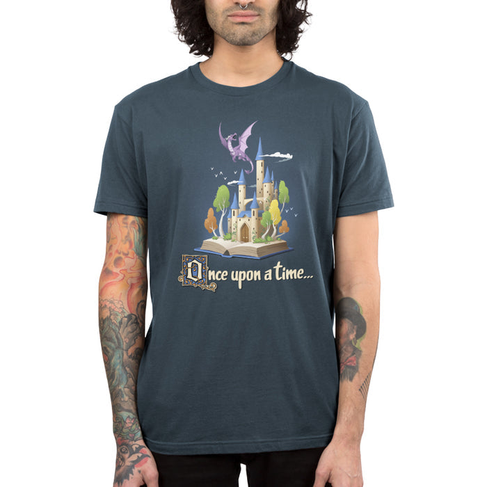 Premium Cotton T-shirt_TeeTurtle denim blue Once Upon a Time apparel featuring an open book with a castle and flying dragon emerging from it.