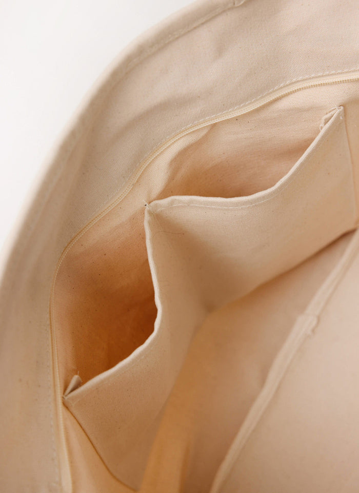 Inside view of the Percival Perci and Rossi Martini Tote Bag, showing the ecru cotton lining, zip, and storage pockets.