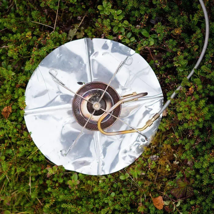 Primus Gravity Camping Gas Stove with a heat reflector on a grassy background