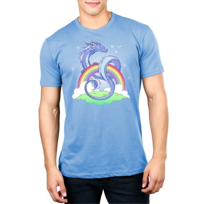 Premium Cotton T-shirt_TeeTurtle light blue Rainbow Protector Premium Cotton T-shirt featuring a smiling dragon protectively looped around a rainbow above a grassy area. There are sparkles around the dragon and rainbow.