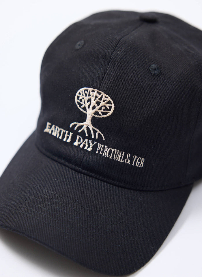 Close-up of the Percival x The Gorilla Brand Earth Day cap in black, highlighting the white embroidered tree design.