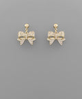 Gold-tone ribbon bow dangle earrings with cubic zirconia accents on a gray background from The Pink Doxie Boutique.