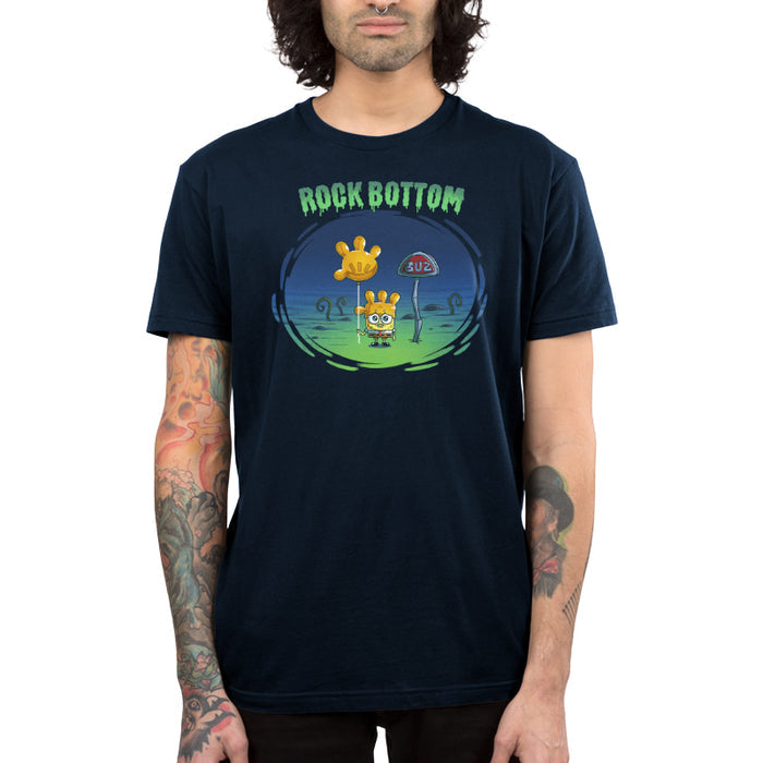Premium Cotton T-shirt_TeeTurtle navy blue SpongeBob Rock Bottom apparel featuring SpongeBob Square Pants holding a yellow balloon that looks like a four fingered hand while wearing a second simliar balooon on his head as a hat. He looks sad and he's next to a "Buz" sign.The words "Rock Bottom" are on top in green and they look like they are melting or dripping.