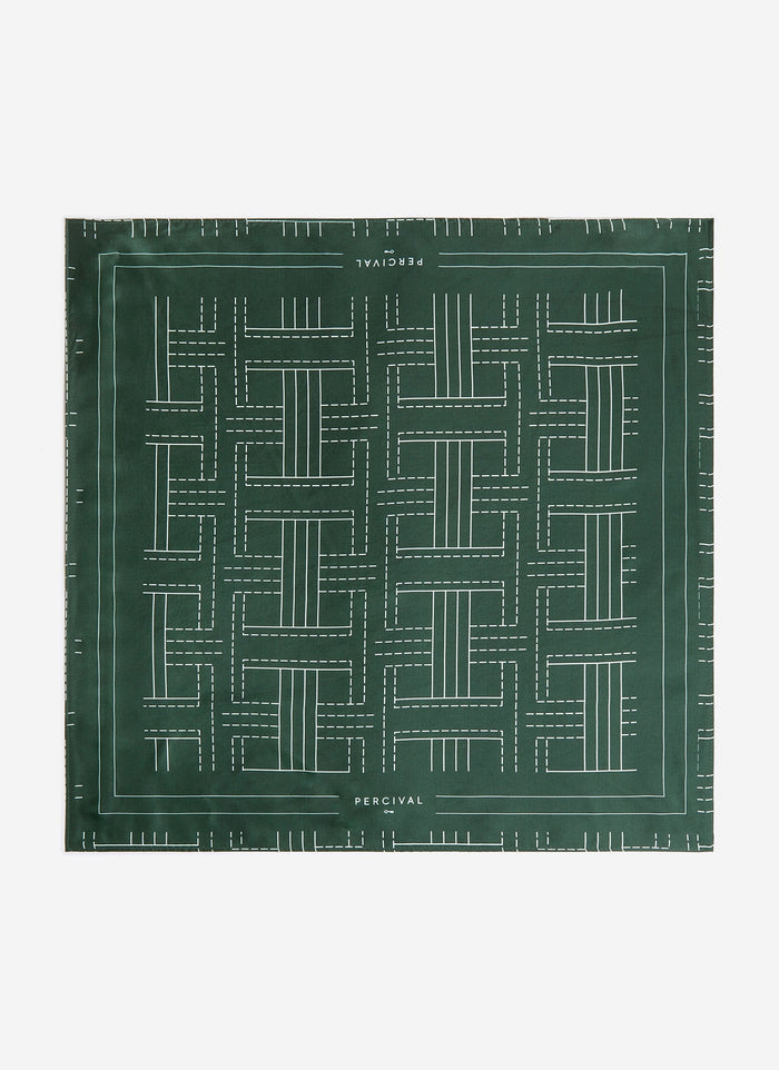 A flat lay of the Percival Sashiko Neckerchief in forest green silk, showing the full geometric stitch-inspired pattern.
