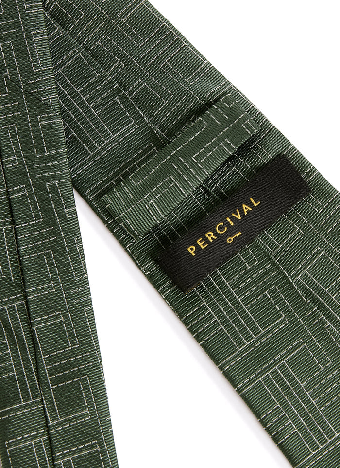 Close-up of the back of the Percival Sashiko Tie in forest green silk, showing the brand label and textured weave.