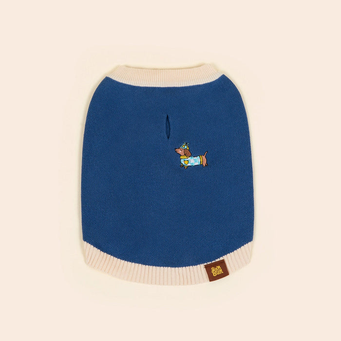 A blue Sassy Woof x Sunbean Dog Tee by Sunbean, featuring cream trim and a small embroidered dog driving a car on the back, is laid flat on a light background—ideal for coordinating matching outfits with your pup.