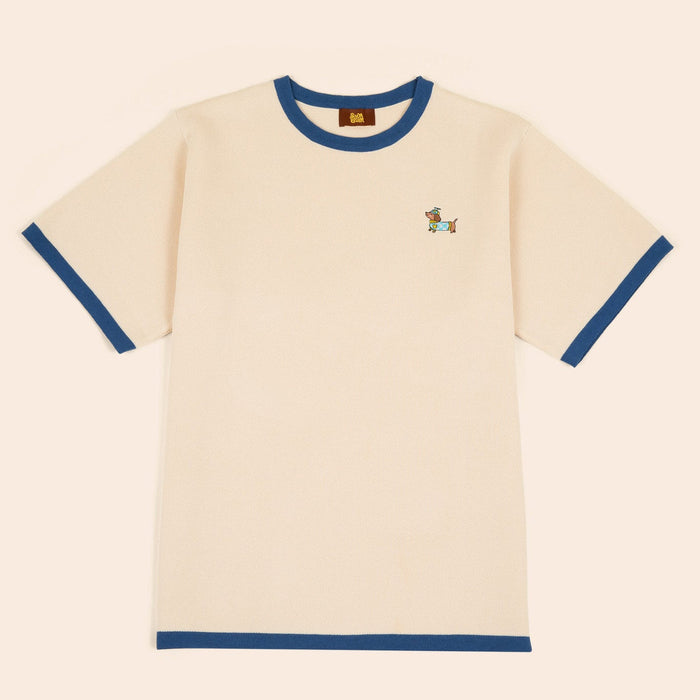 The Sassy Woof x Sunbean Human Tee by Sunbean is a beige short-sleeve t-shirt with blue collar and sleeve cuffs, featuring a small embroidered dog on the left chest.