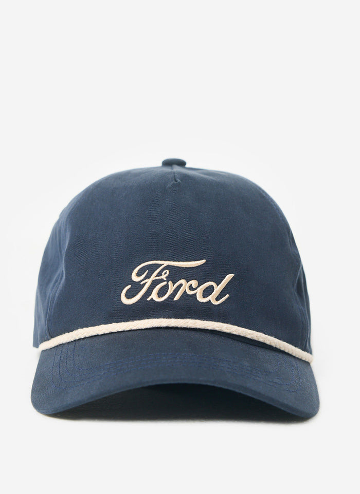 The navy Percival x Ford soft trucker cap with its ecru embroidered logo and rope detail.