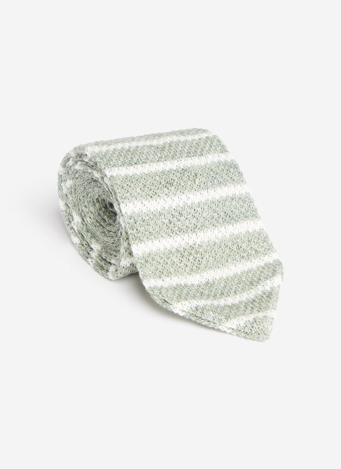 A studio shot of the Percival Stripe Linen Tie in Forest Marl, rolled up to show its green and white striped linen texture.