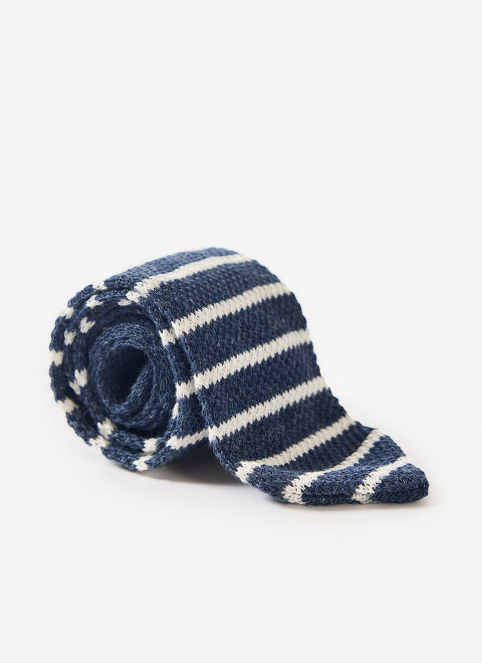 Percival navy marl and white striped linen tie, rolled up against a white background.