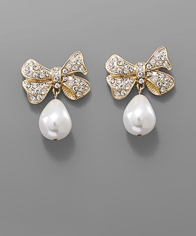 Teardrop pearl bow earrings with crystal accents in gold and silver tones displayed on a neutral background from The Pink Doxie Boutique.