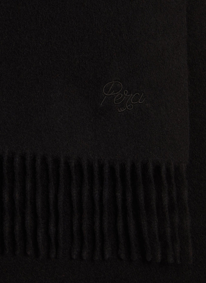 A close-up of the black wool Tolkein Scarf from Percival, showing the tonal embroidery and fringed edge.