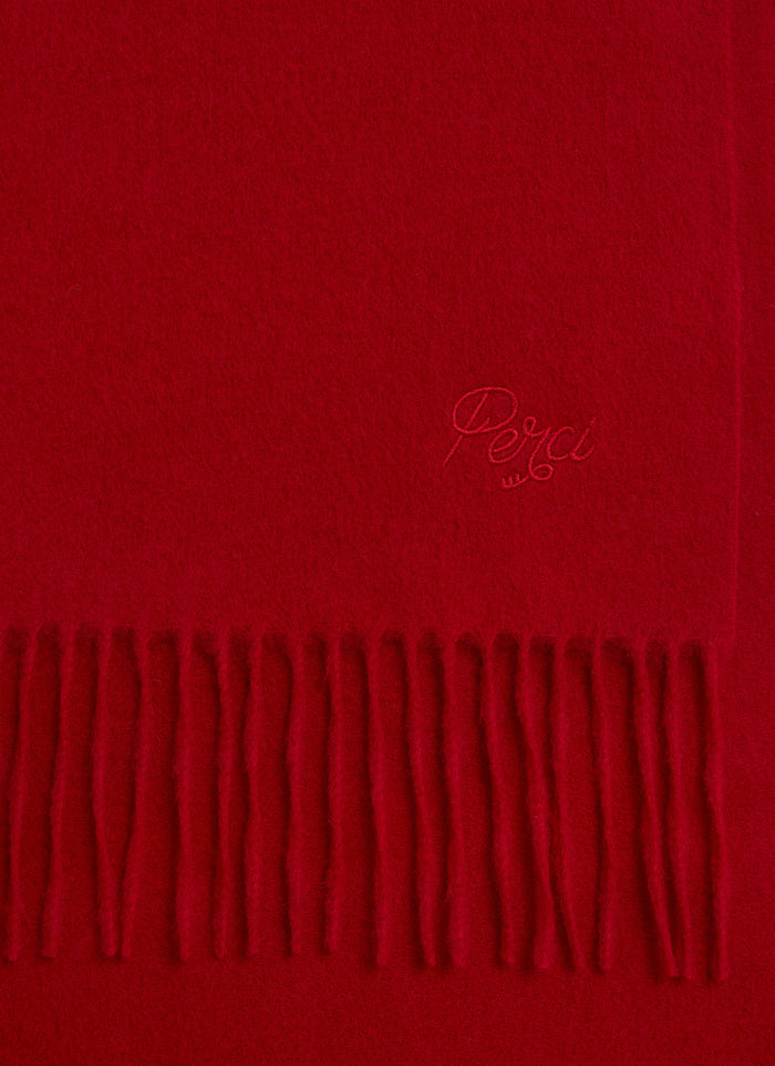 A close-up of the red wool Tolkein Scarf from Percival, showing the tonal embroidery and classic fringed hem.