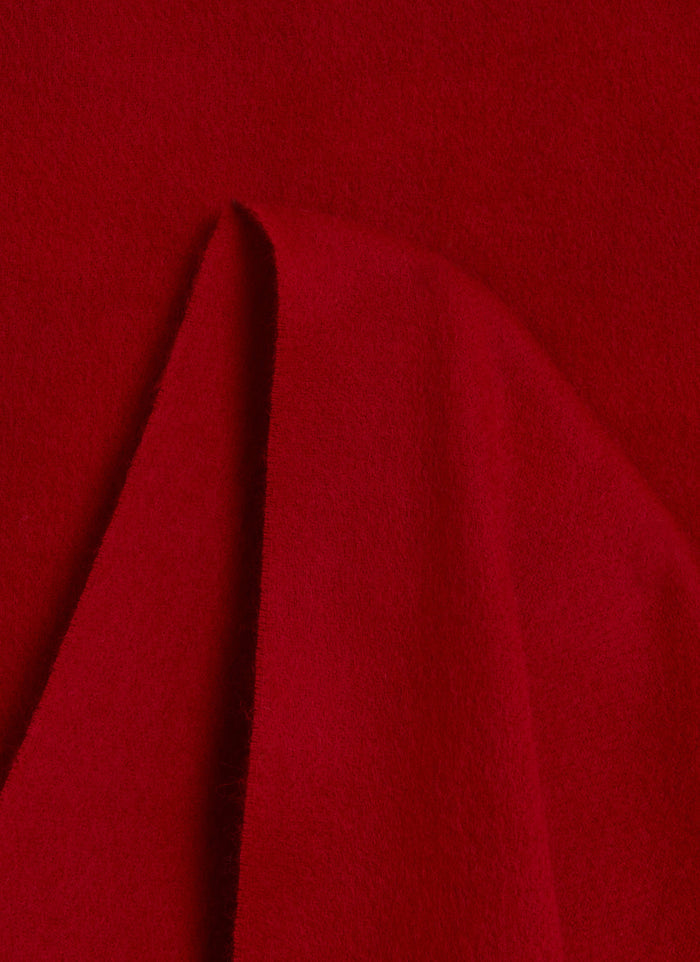 A close-up shot of the Percival Tolkein Scarf, highlighting the soft texture of the red 100% wool fabric.