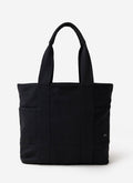 The Percival Tote Bag in black heavy-weight canvas, featuring sturdy handles and external pockets, shot in a studio.