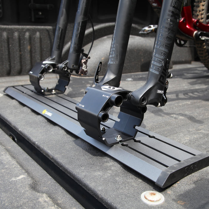 Saris Traps Triple Track (TRK33/TRK34) — three-carrier system in truck bed, empty