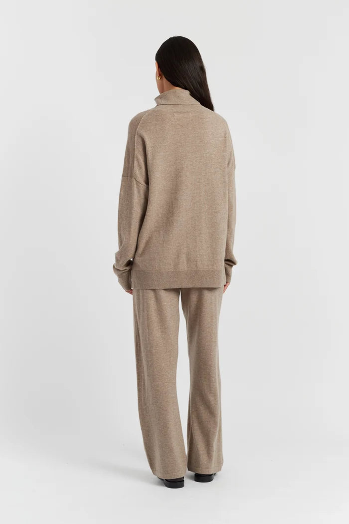 Woman wearing a beige suit on a white background