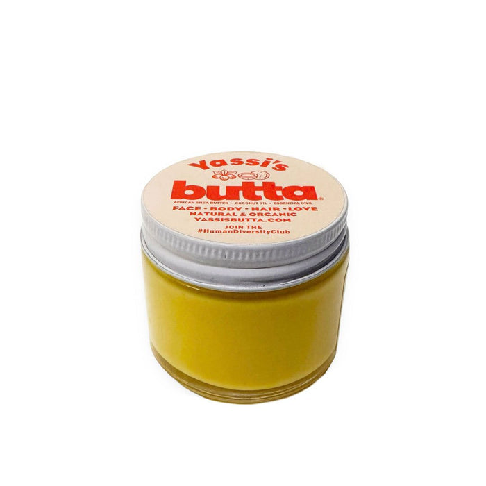 Travel-size balm jar with yellow body and white screw lid, Yassi's Butta label